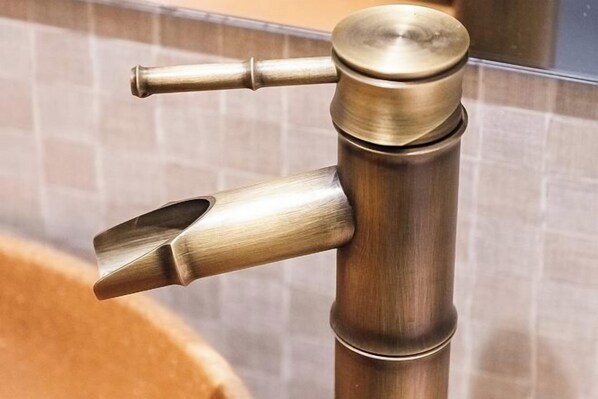 A brass faucet with a modern design, mounted on a wall with a tiled backsplash. - Kyomachiya Miss (Kyoto)