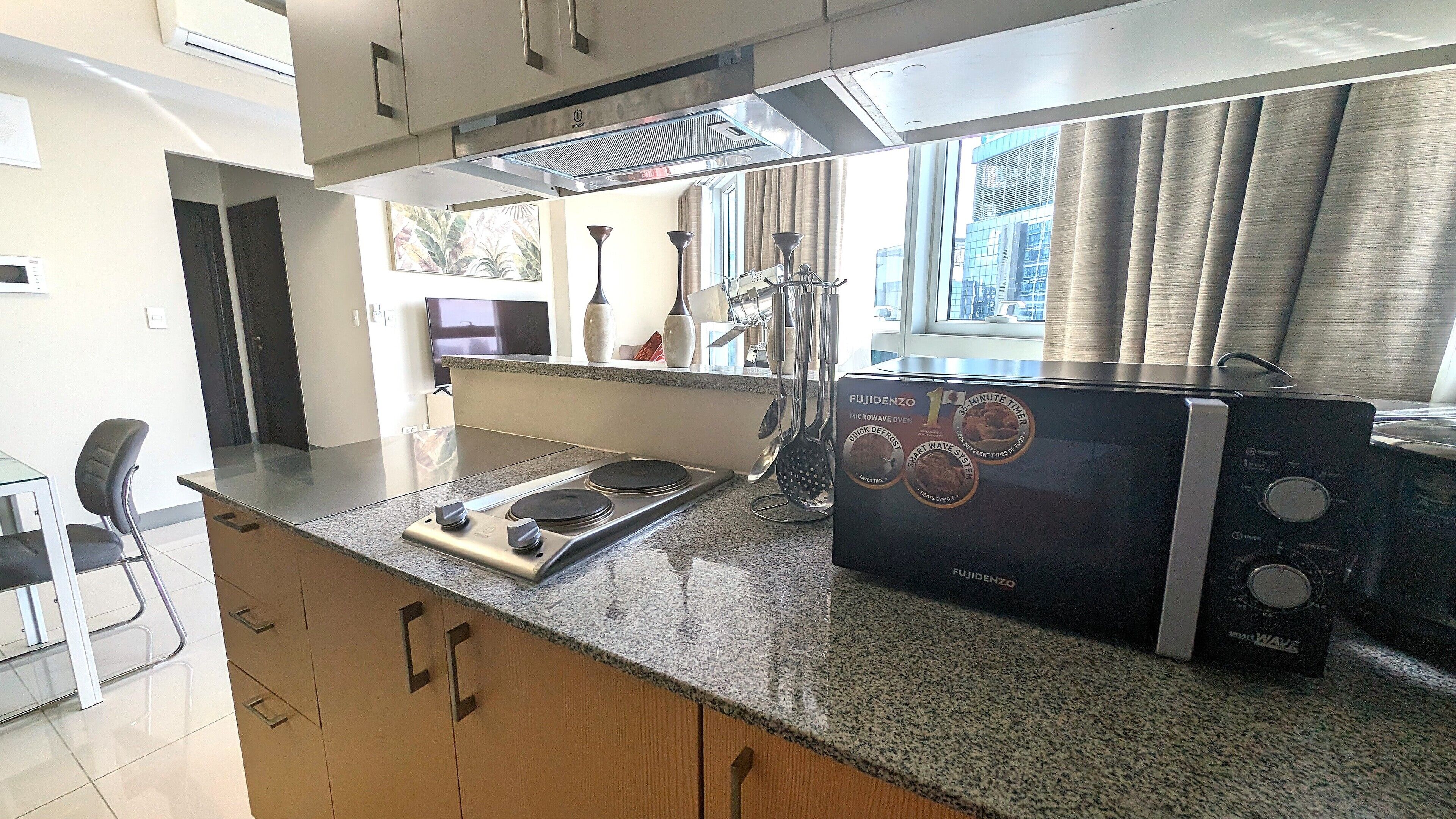 A kitchen with a microwave, stove, and modern cabinetry.