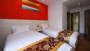 A hotel room with two beds, a red accent wall, and a modern light fixture. - Shipu Xinxing Hotel (Xiangshan)