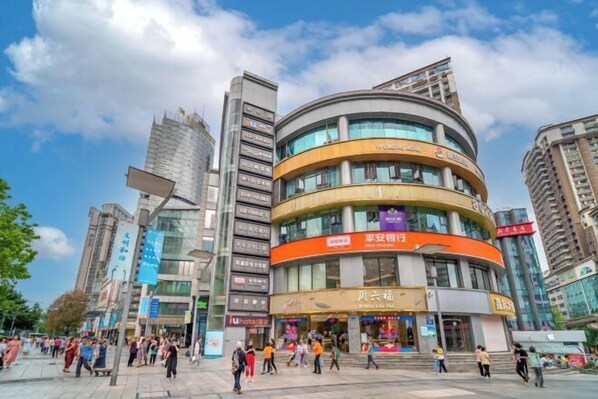 A modern commercial building with multiple floors and a curved facade.