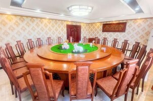 A conference room with a round table, chairs, and a decorative centerpiece.