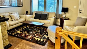 A living room with a beige sofa, a coffee table, a patterned rug, and a wooden chair. - #1-cnvnt 4B3B fits 9PPL, 15 mins walk to heavenly (South Lake Tahoe)
