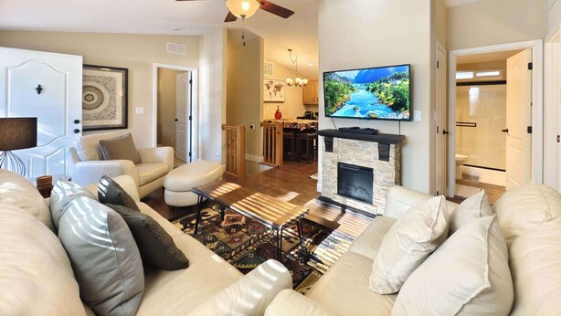 A living room with a fireplace, a ceiling fan, and a TV mounted on the wall. - #1-cnvnt 4B3B fits 9PPL, 15 mins walk to heavenly (South Lake Tahoe)