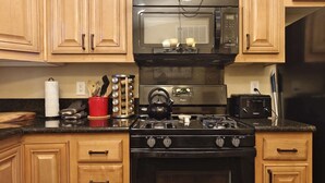 A kitchen with wooden cabinets, a microwave, a stove, a toaster, and a kettle. - #1-cnvnt 4B3B fits 9PPL, 15 mins walk to heavenly (South Lake Tahoe)