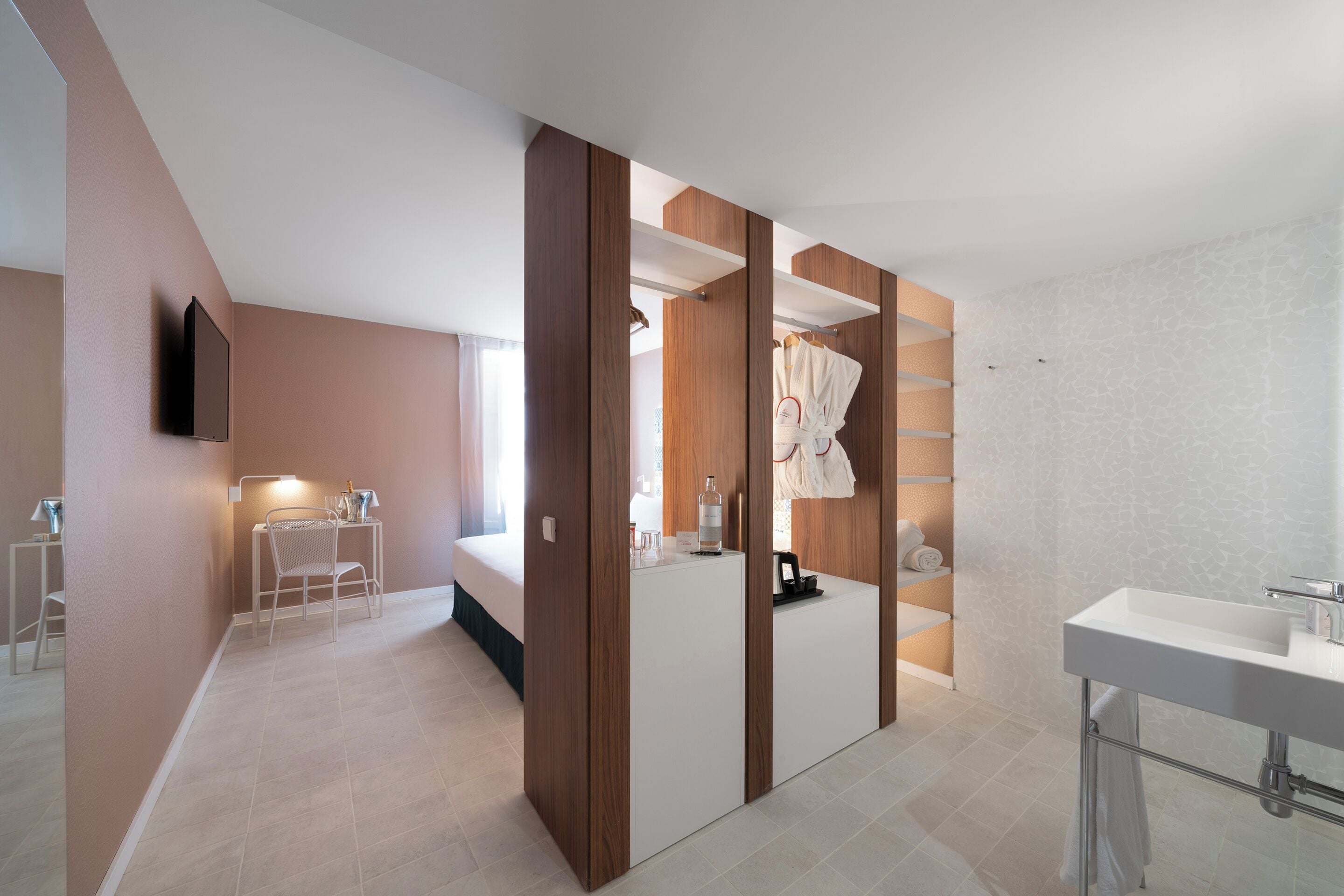 A modern bathroom with a large mirror, a white sink, and a shower area.
