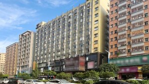 A multi-story building with a modern architectural design, featuring a mix of balconies and large windows. - Kaerlaisi Boutique Stay (Dongguan Chang'an) (Dongguan)