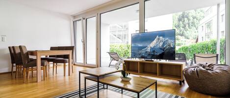 Comfort Apartment | Living area | 55-inch flat-screen TV with cable channels, Netflix, heated floors