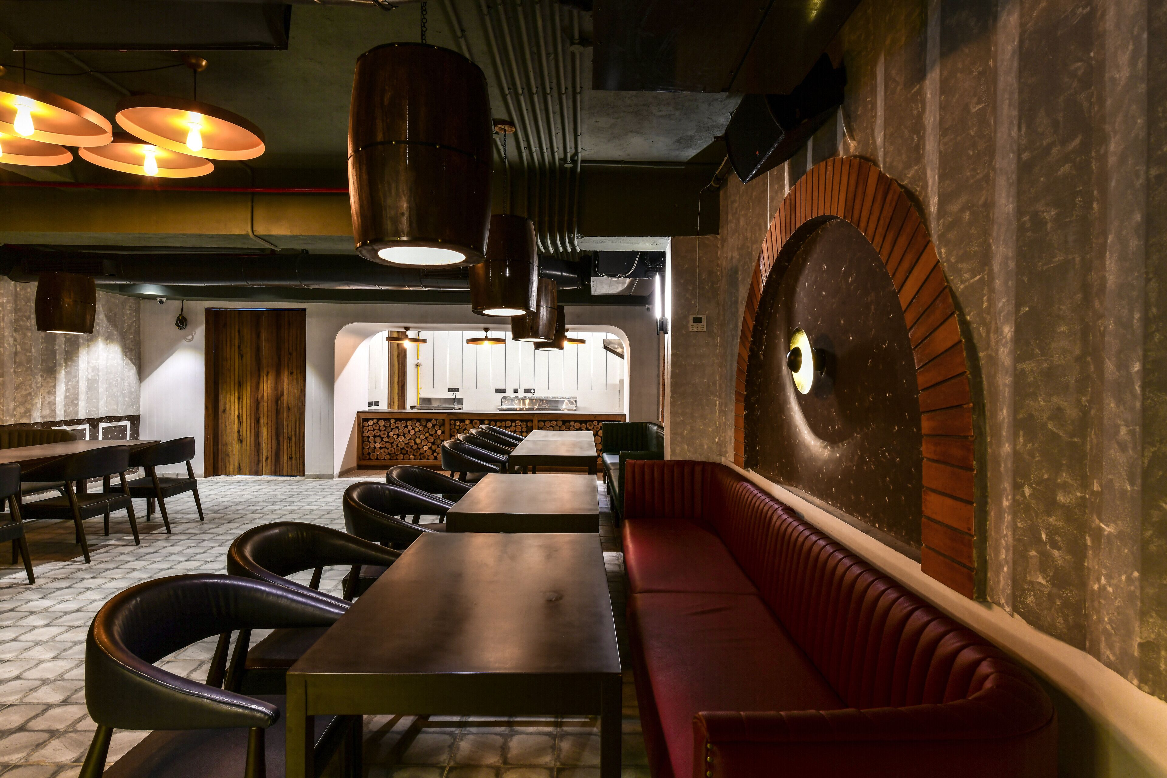 A restaurant interior with a long counter, multiple tables, and a red booth.