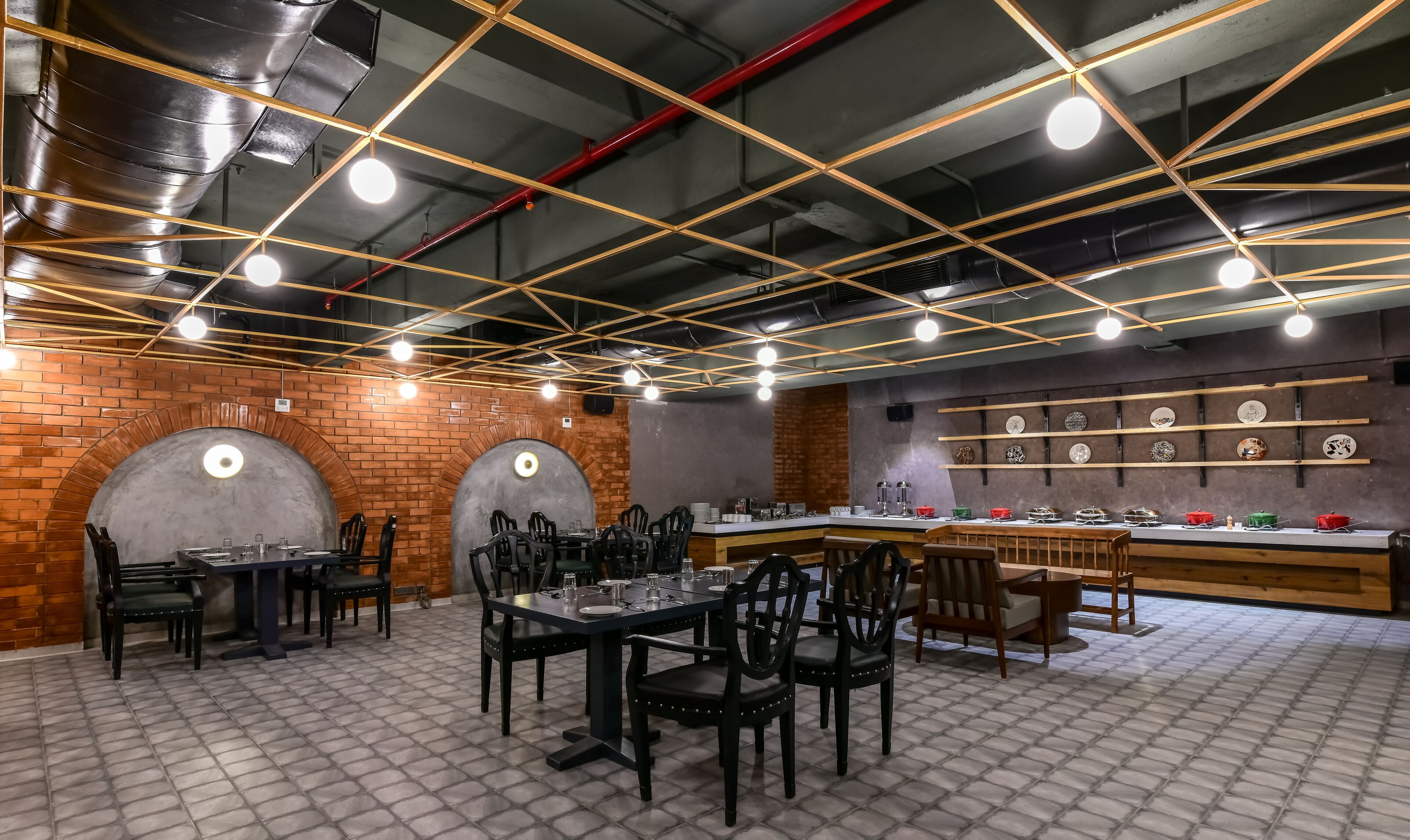 A restaurant with brick walls, a central bar area, and multiple dining tables with chairs.