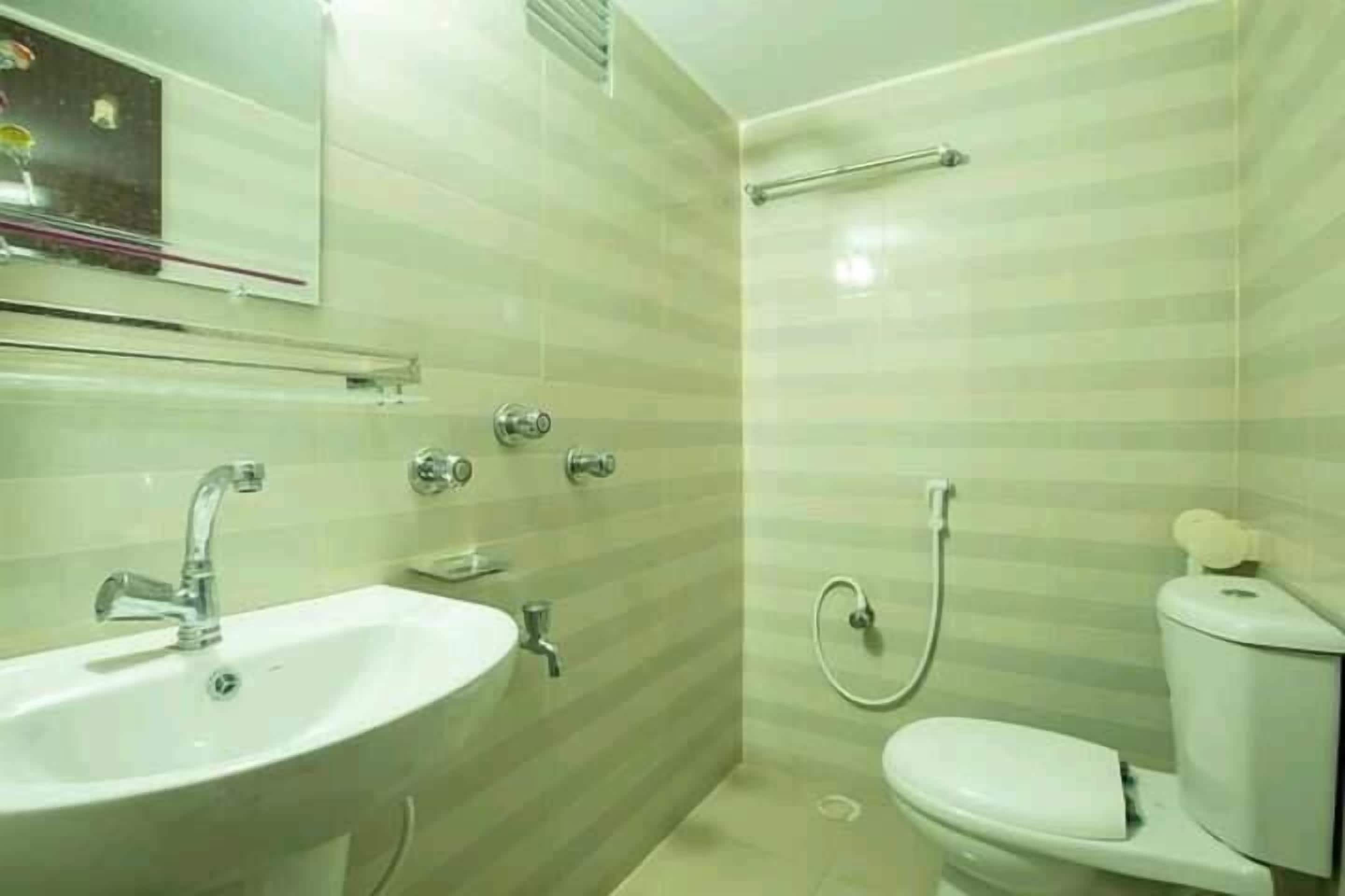 A bathroom with a sink, toilet, and shower.