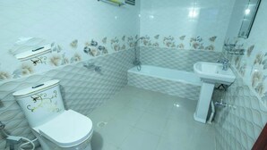 A bathroom with a toilet, sink, and bathtub. - Resort Rain View Hotel Cox's Bazar (Cox's Bazar)