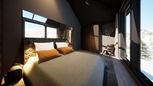 Een moderne slaapkamer met een groot bed, een stoel en zicht op een besneeerd landschap door grote ramen.