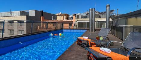 Outdoor pool, open 9:00 AM to 9:00 PM, pool loungers