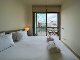 Desk, iron/ironing board, bed sheets
