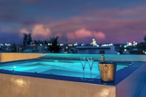 A rooftop pool area with two empty glasses and a champagne bucket. - Alimos Luxury 3Bd w Outdoor Jacuzzi (Alimos)