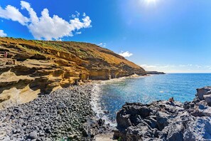 A coastal landscape with rocky terrain and clear blue water. - Atlantic Sky Panorama (Costa del Silencio)