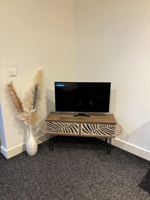 Enjoy a cozy evening in with a flat-screen TV and a stylish vase.