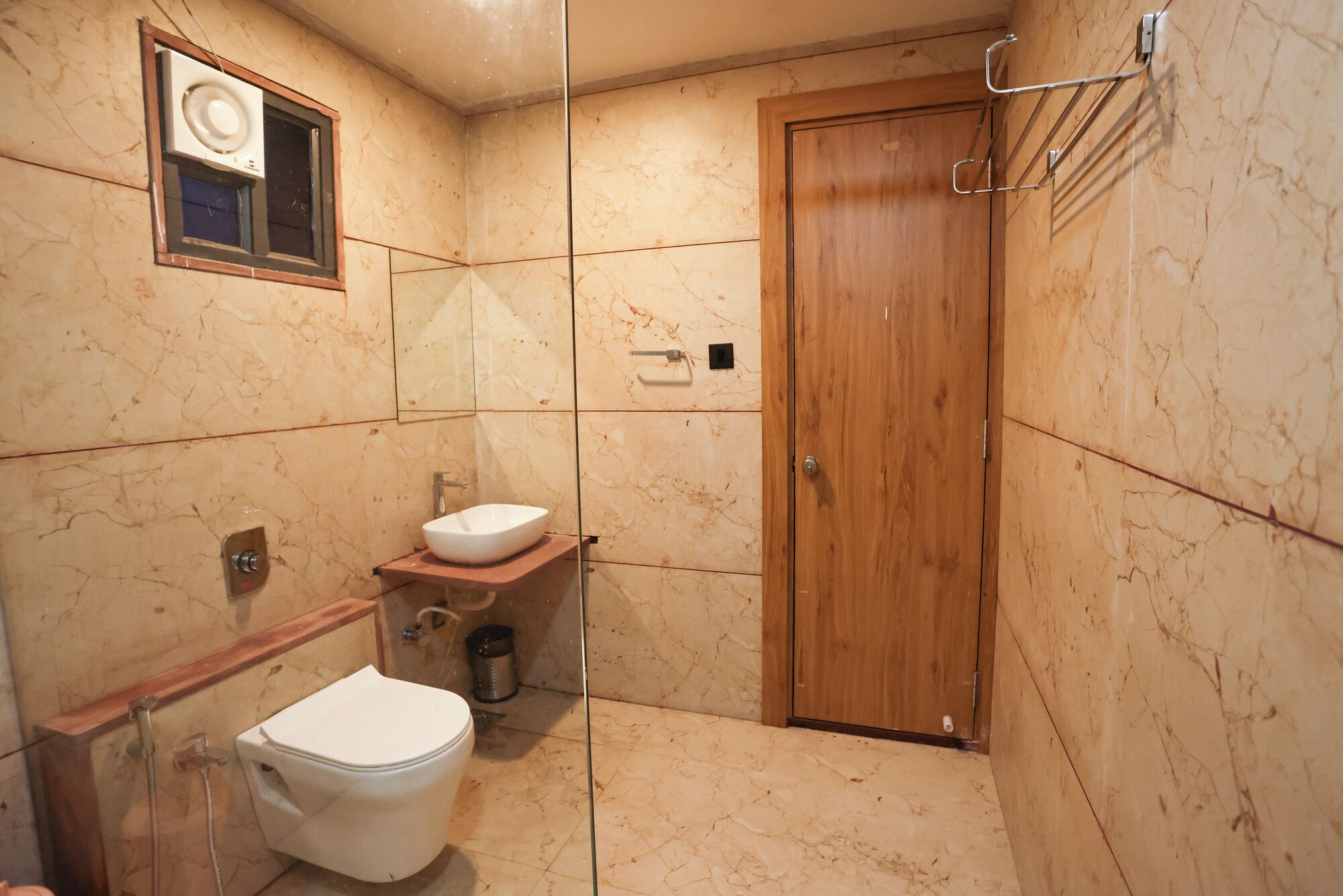 A bathroom with a toilet, sink, and shower.
