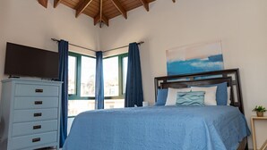 A bedroom with a bed, a dresser, a TV, and a painting. - Palm Paradise at Tierra Del Sol - 2 bedroom/2 full baths and 2 1/2 baths is just waiting for you to enjoy some sun and fun! (Noord)