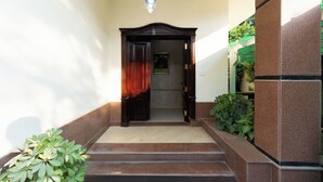 A staircase leading to a wooden door with a picture frame above it.