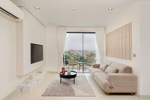 Business Apartment | Living area | 55-inch Smart TV with digital channels - Velea Serviced Apartments & Suites (Siem Reap)