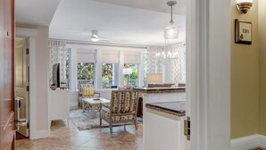 A spacious kitchen with a dining area, a chandelier, and a view of the outdoors. - Bayview Luxury: Sandestin Retreat, Resort Perks (Miramar Beach)