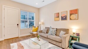 A living room with a beige sofa, a glass coffee table, a yellow armchair, and a green side table with a lamp. - Near Coffee/Food, NOOGA NOOK 10 mins Chattanooga! (Chattanooga)