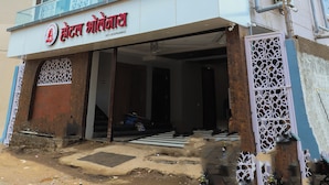 A multi-story hotel with a modern facade, balconies, and air conditioning units. - Hotel Bholenath (Khandwa)