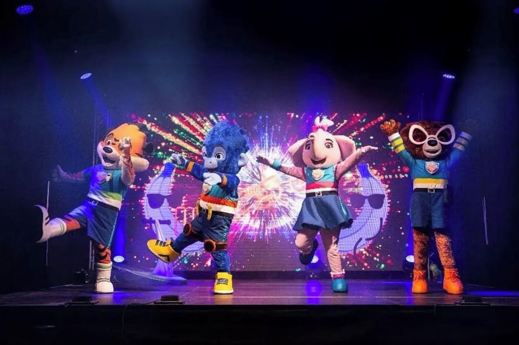 A stage with four animated characters performing.
