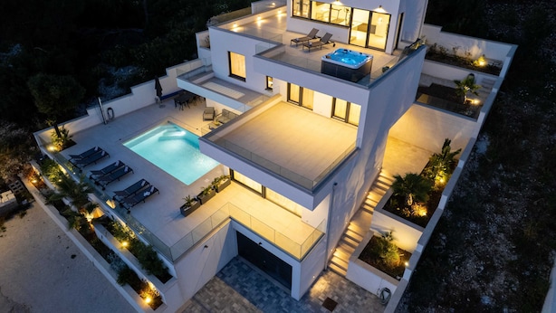 A modern multi-story house with a swimming pool, outdoor seating, and a hot tub. - Villa Oasis (Trogir)