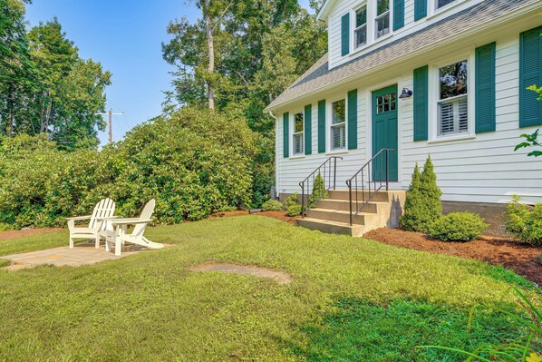 A white house with green shutters, a front porch, and a small garden with two Adirondack chairs. - 2 Mi to Dtwn: 2-acre Retreat w/ Large Yard! (Madison)