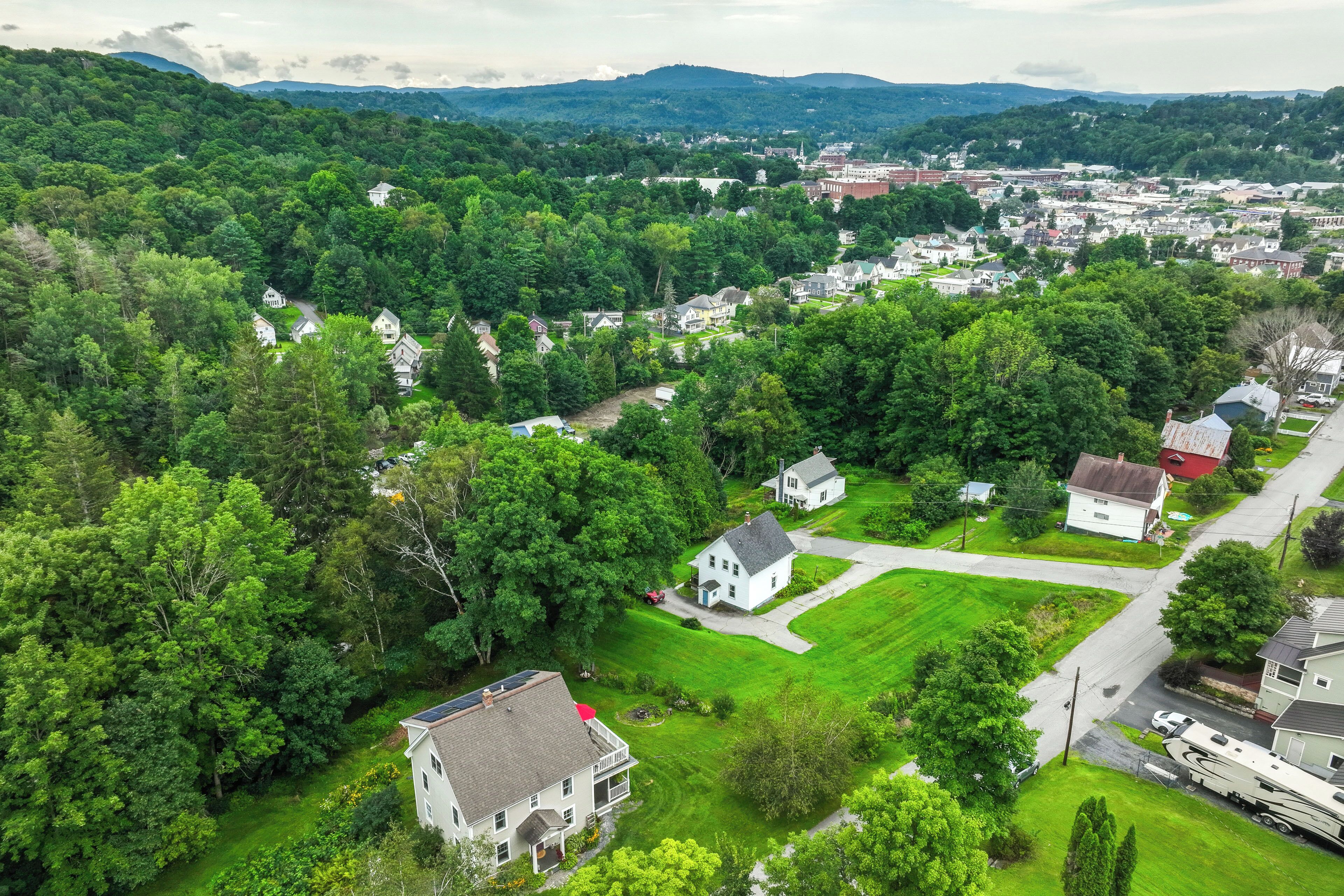 An aerial view of a residential area with houses, roads, and a large RV park.