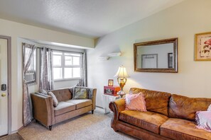 A living room with two sofas, a table with a lamp, a mirror, and a window with curtains. - 2 Mi to Dtwn: Missoula Duplex w/ Fenced Yard (Missoula)