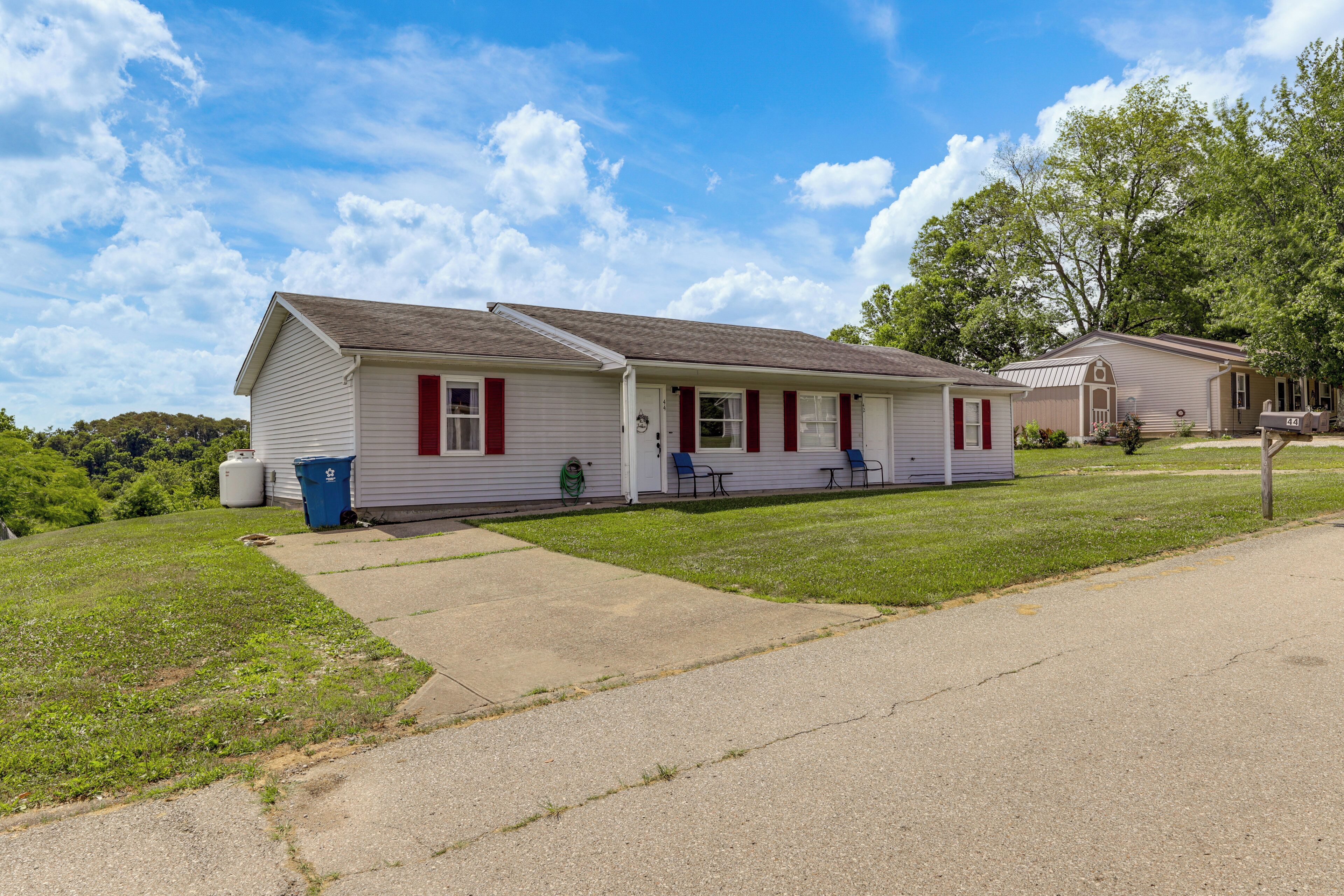 A single-story motel with a covered porch and a small attached garage.