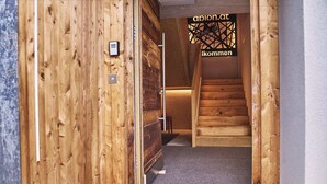 A wooden interior with a staircase leading to a higher level. - Chalet Ablon (Saalbach-Hinterglemm)