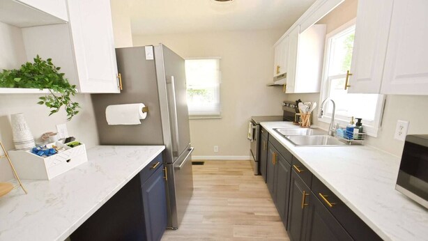 A modern kitchen with a refrigerator, sink, and cabinets. - 5 min walk to Notre Dame! Modern home (517) (South Bend)