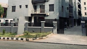 A multi-story residential building with balconies, air conditioning units, and a gated entrance. - PON Bliss Apartments (Abuja)