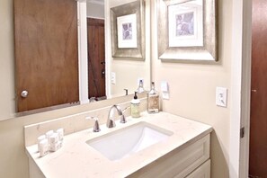 Bathroom features a large sink, two faucets, and a countertop.