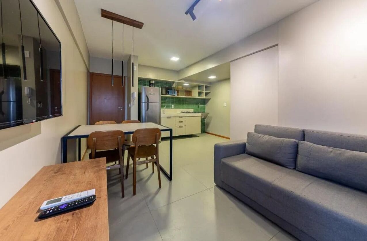 A compact living space with a kitchenette, a dining area, and a seating area.