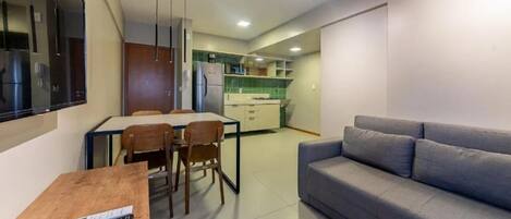 A compact living space with a kitchenette, a dining area, and a seating area.