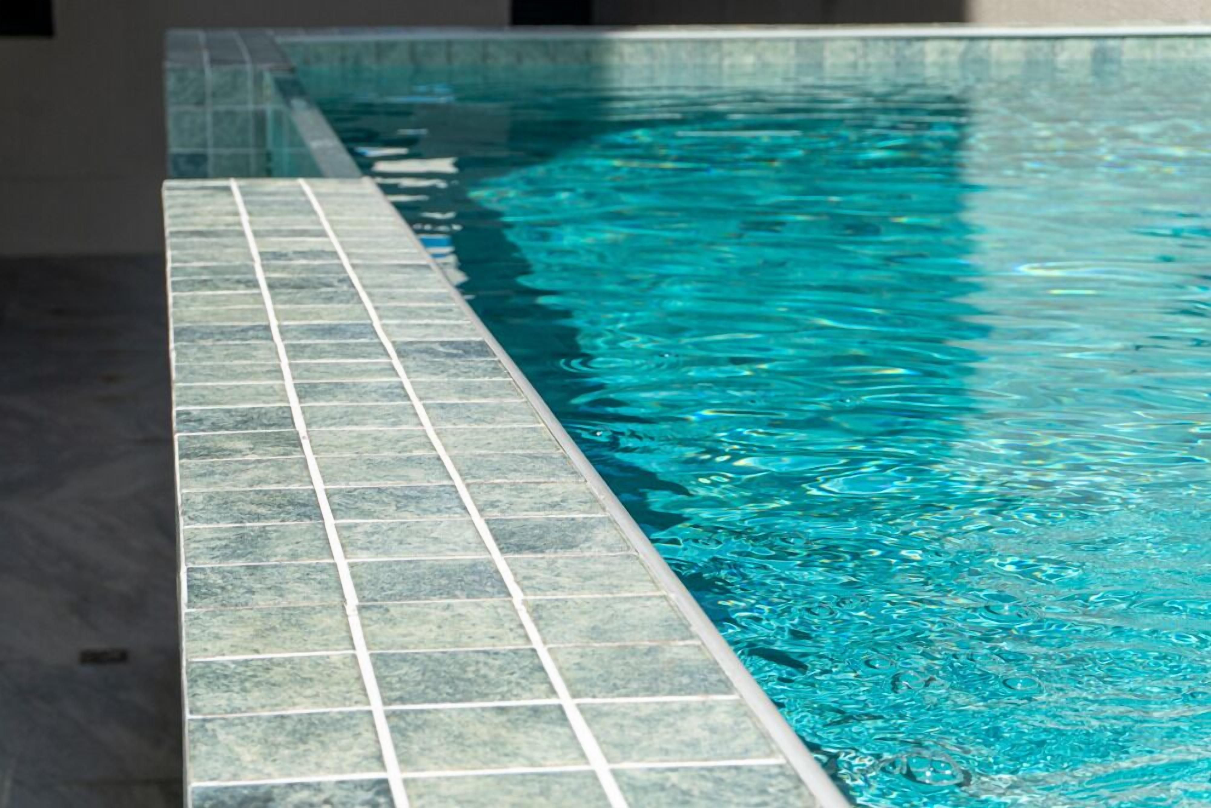A swimming pool with a tiled edge.