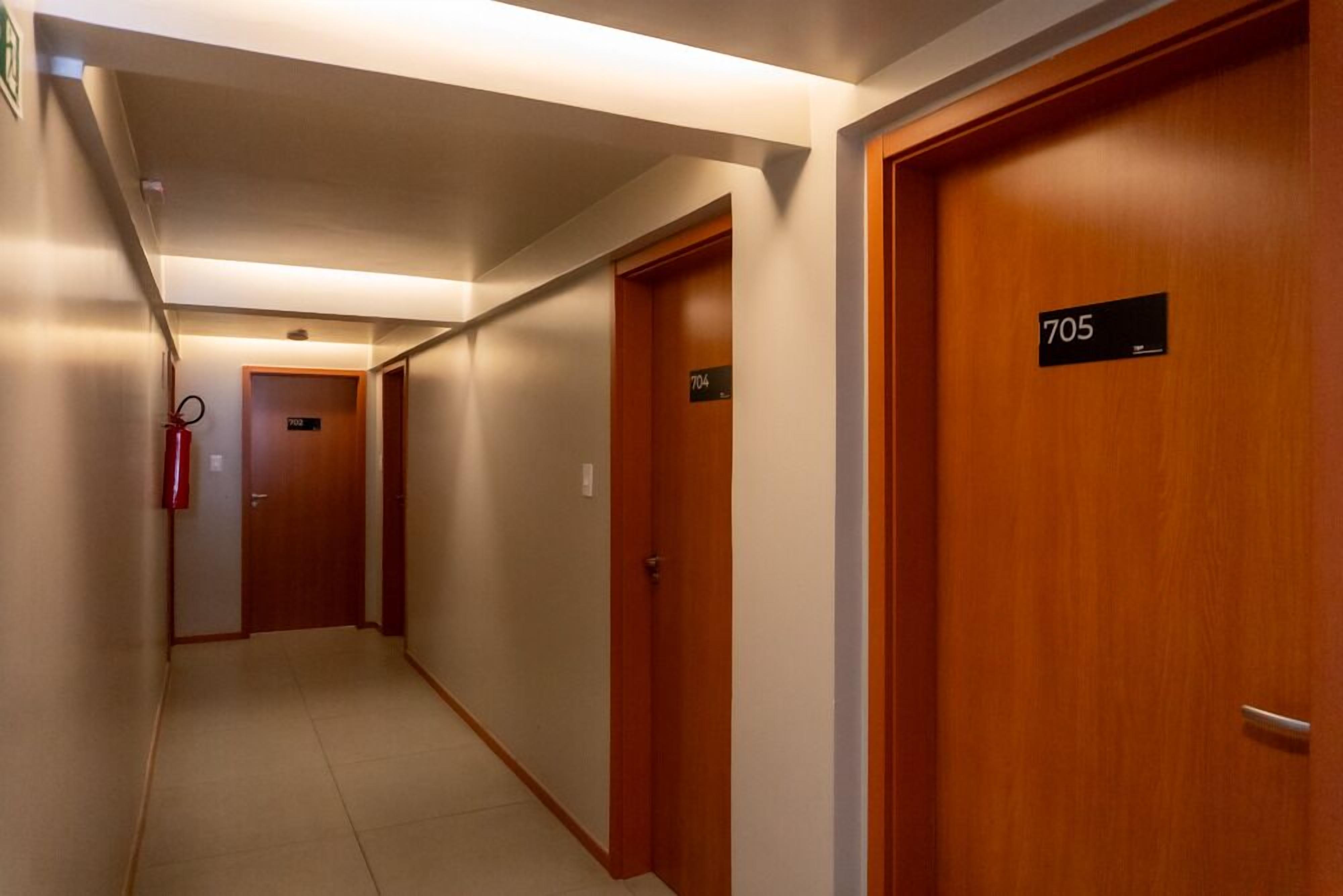 A hotel hallway with doors numbered 704, 705, and 706.
