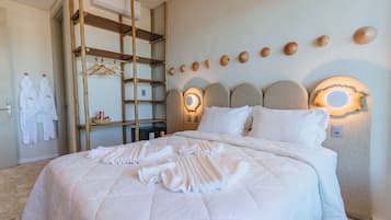 A neatly made bed with a quilt, a wooden ladder, and a wall-mounted shelf with towels and a basket.