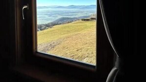 A window with a view of a hilly landscape. - Apartment Smreka - Amazing place in the mountains - Pr Ambružarju (Kranj)