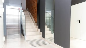A modern interior with a staircase, a glass railing, and a door. - New Apartment Boston - Center/Comfort/Wi-Fi (Valladolid)
