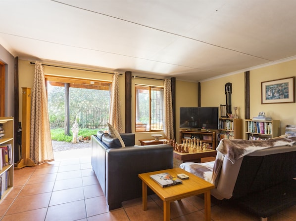 Apartment, 2 Bedrooms, Smoking, Patio | Living area | Books - Experience Nature at Brenton on Sea With Breakers Dolphins and Whales (Knysna)