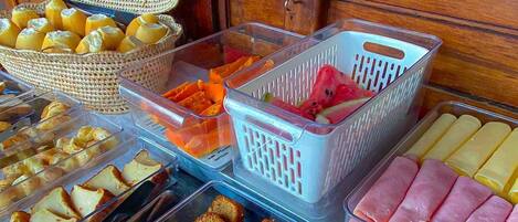 A buffet with various food items including cakes, pastries, and meats.
