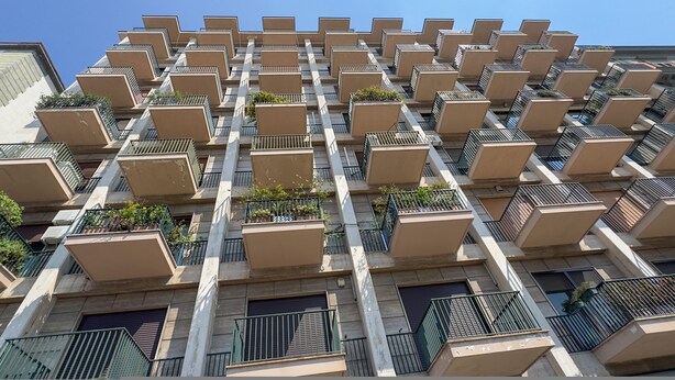 A high-rise building with multiple balconies, each with a small garden area. - Riviera di Chiaia 207 (Naples)