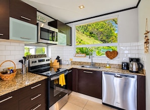 A modern kitchen with a stainless steel dishwasher, a microwave, and a stove.