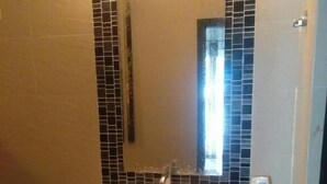 A bathroom with a rectangular sink, a mirror, and tiled walls. - Baan Bonhuer Pool Villa Hua-Hin (Hua Hin)